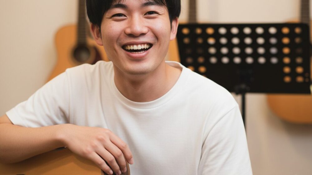 Smiling-man-with-guitar-in-hand